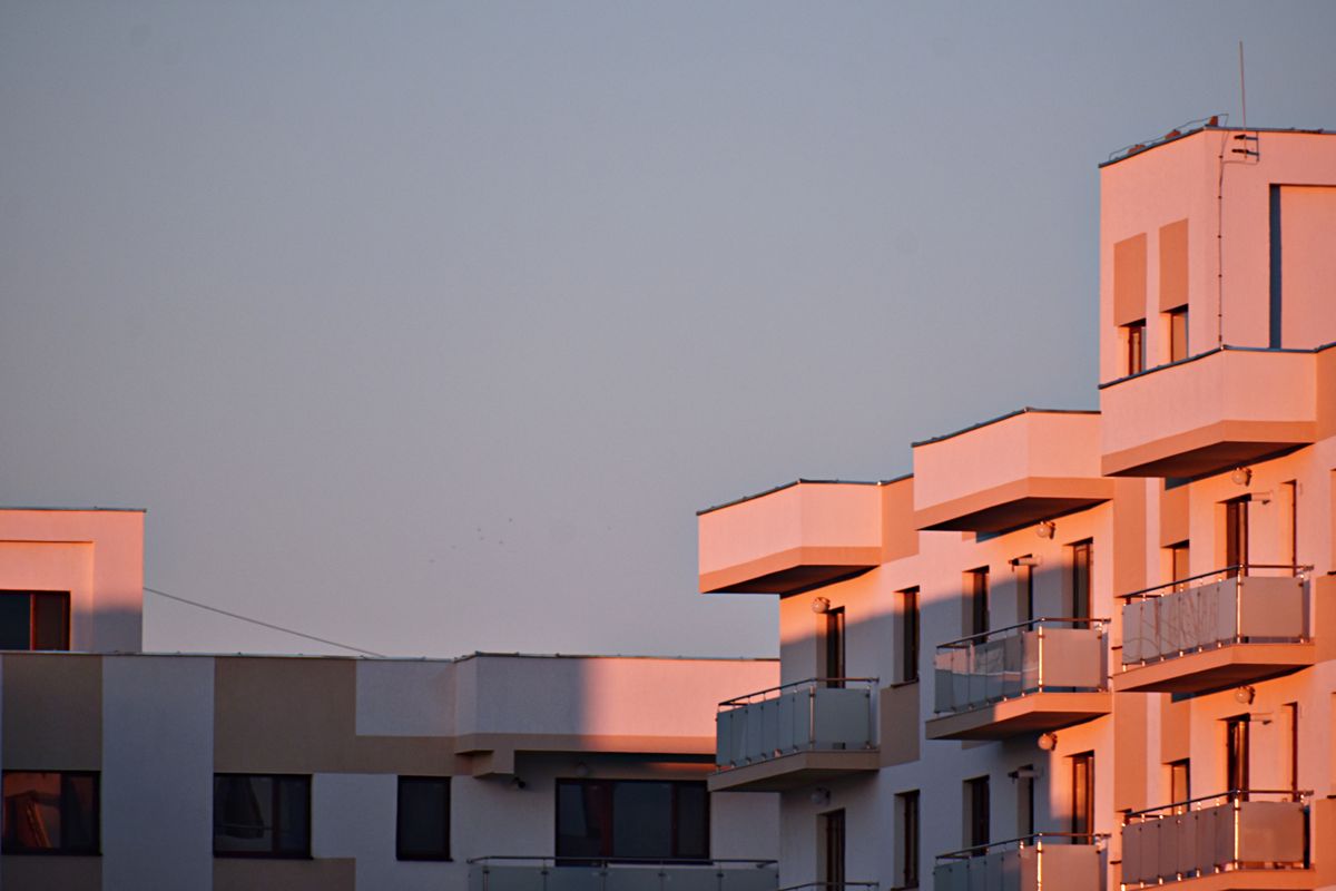 Modern apartment building with balconies in golden sunset light
