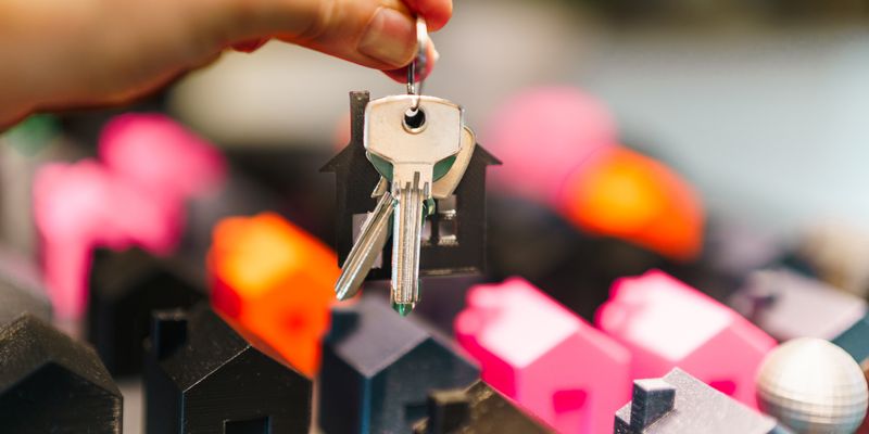 Real estate property keys and miniature houses representing Istanbul real estate investment 2026 market